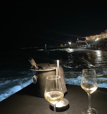two wine glasses with wine glasses on a table