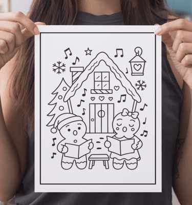 a woman holding up a drawing of a house