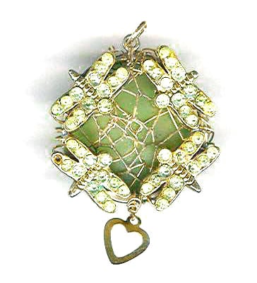 raw aquamarine pendant wrapped with gold-filled wire and dragonfly charms.