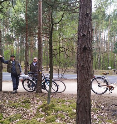 A couple standing next to each with bicycles