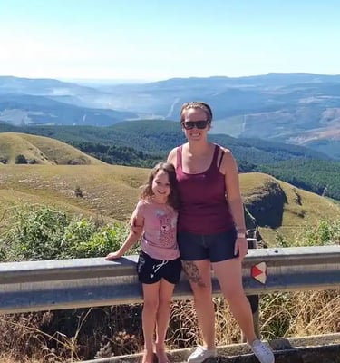 woman standing with child in front of view