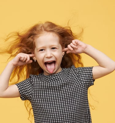 a young girl with her tongue sticking out of her tongue