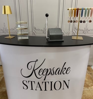 Custom keepsake station booth featuring personalized leather keychains and a photo punching machine.