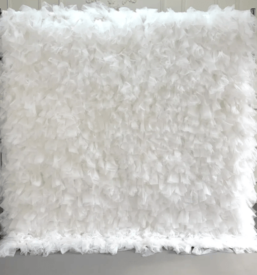 Elegant white ruffled tulle backdrop for wedding and event decor.