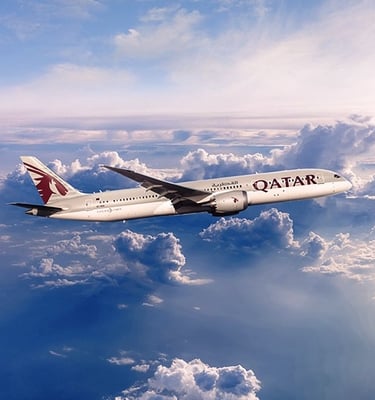 a plane flying over a cloud filled sky