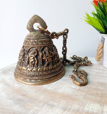 a ganesh with a chain link and a flower in a vase