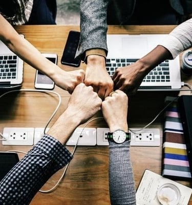 a group of people holding hands in a circle
