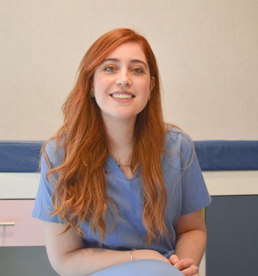 a woman in scrubies sitting on a chair