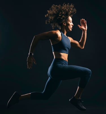 a woman in a sports bra top running in the dark