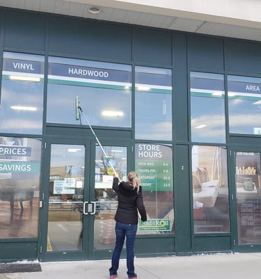 a woman window cleaning a store bantford ontario