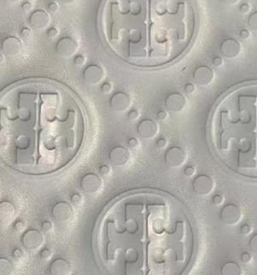 Detailed debossed pattern on material, creating a subtle and tactile finish by King Fly.