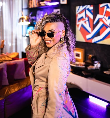 a woman in a beige coat and sunglasses