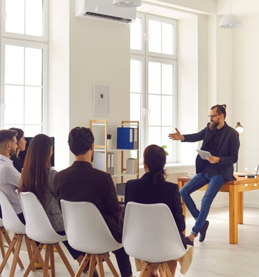 GLm LAW a man in a black shirt is standing in front of a group of people