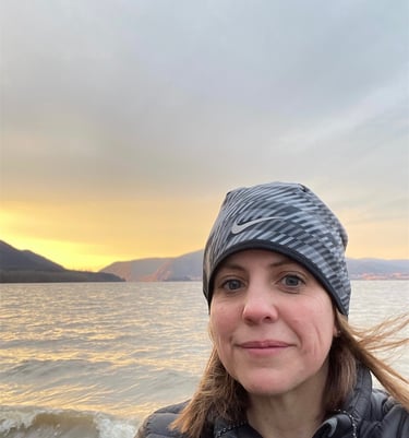 Amy McArdle in a hat by the Hudson River