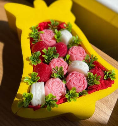 a custom gift box in shape of a bell filled with flowers and treats