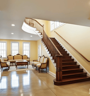 a living room with a staircase spotless