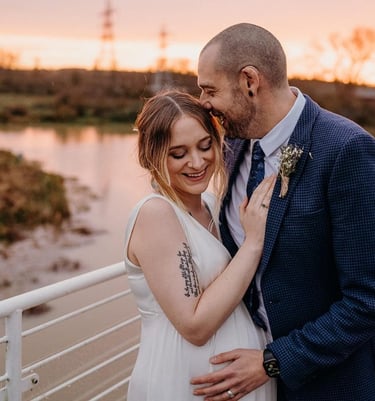 a bride and groom look happy pictured on the top deck of the ark northampton at sunset