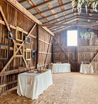 a barn wedding reception tables with table cloths