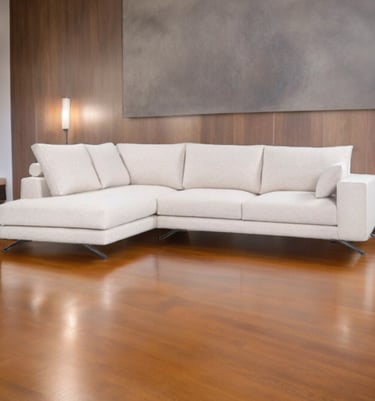 a white couch with a large white couch and a lamp