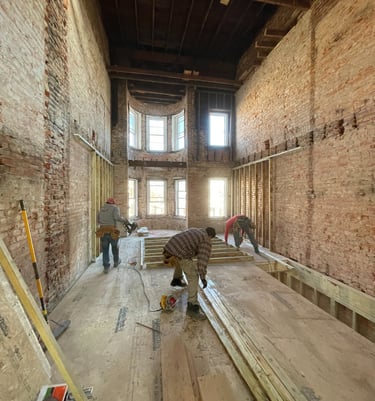 a man is working on a wooden floor