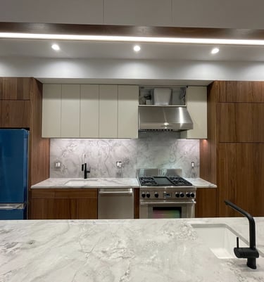 a kitchen with a marble counter top and a blue refrigerator
