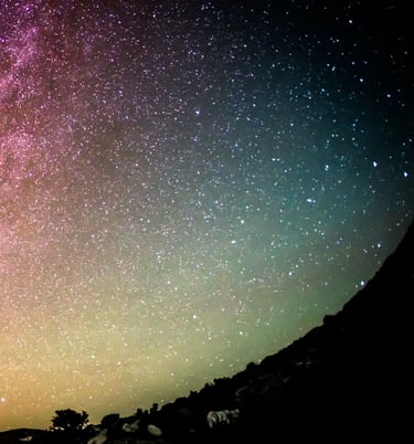 Silhouette of a man looking up to the night sky