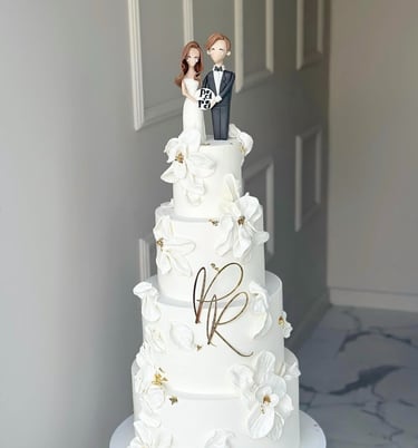 a wedding cake with a bride and groom on top of it