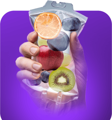 a person holding a bag of fruit on a purple background