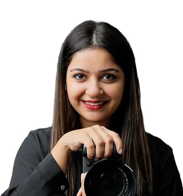 Huma Photographer - a woman holding a camera and smiling