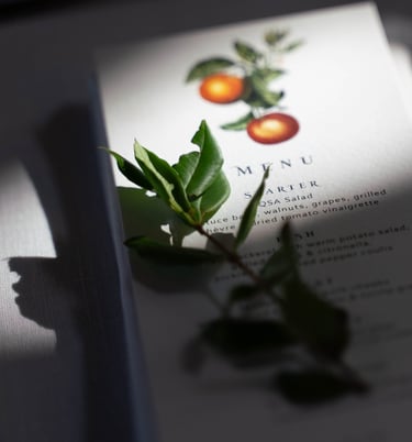 a menu card with a leafy branch of a plant