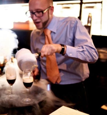 a man in a tie and shirt making molecular cocktails