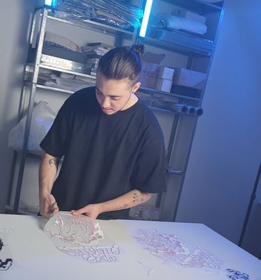 a man in a black shirt is cutting paper with scissors