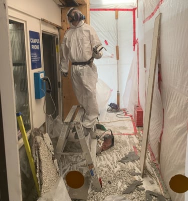 abatement worker removing asbestos