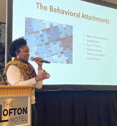 Beatrice Adenodi speaks to a group of professionals at The Lofton Hotel