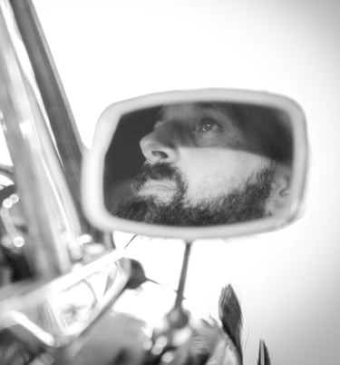 a man with a car and a car in a mirror