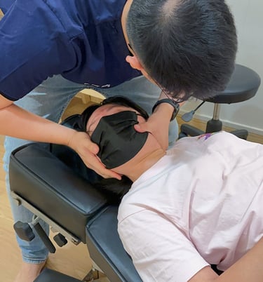 Chiropractor performing neck adjustment for pain relief at Sinisana Chiropractic
