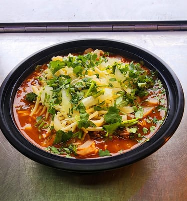 a bowl of soup with broccoli and cheese