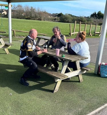 a group of archers having lunch at a picnic table