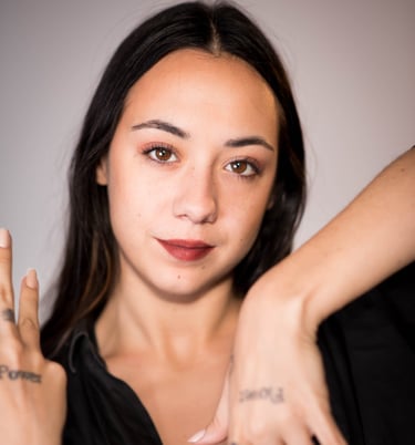 a woman with tattoos on her hands and a tattoo on her hand