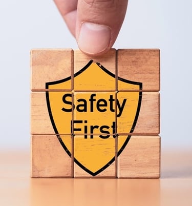 Building blocks with the graphic of a yellow shield saying "Safety First" on the front