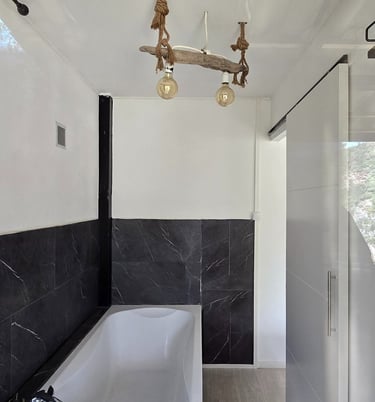 a bathroom with a tub and a chandelier