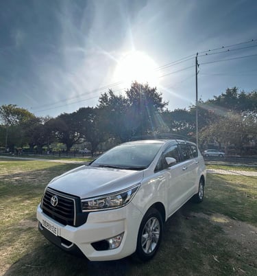 a white toyota fortuner parked in a field