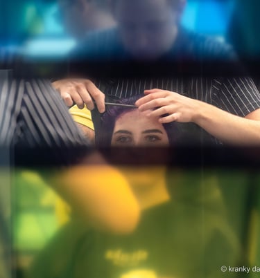 woman having her done in the hairdressers but obscured by the shop window