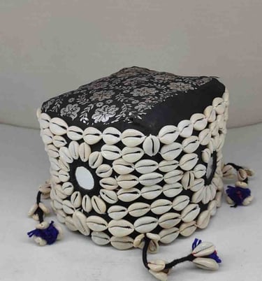 "Black bamboo basket wrapped in cotton fabric with tribal-style shell accents and floral garland-Suitable for export"