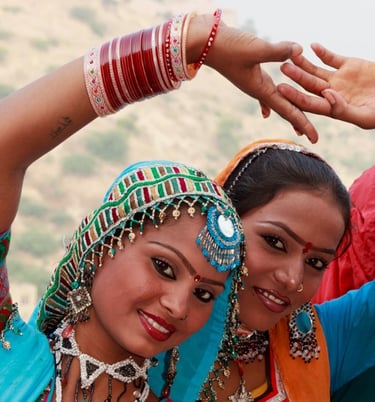 two women in colorful clothes and jewelry