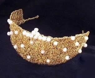 a gold crown tiare with pearls and pearls