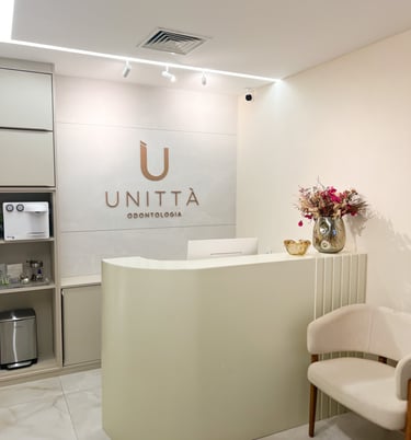 a reception area with a reception table, flowers and chairs