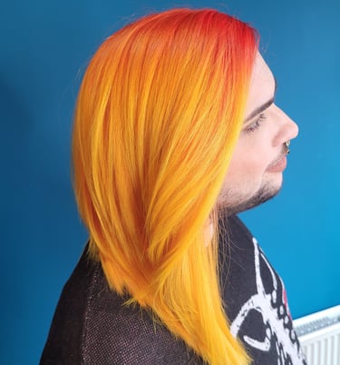 person with orange to yellow ombre hair