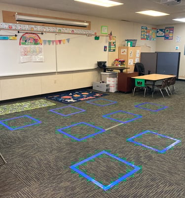 a classroom room with a whiteboard and blue tape tape