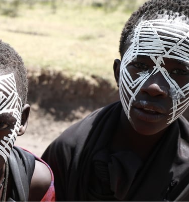 two hazda tribal young boys with painted faces and painted faces